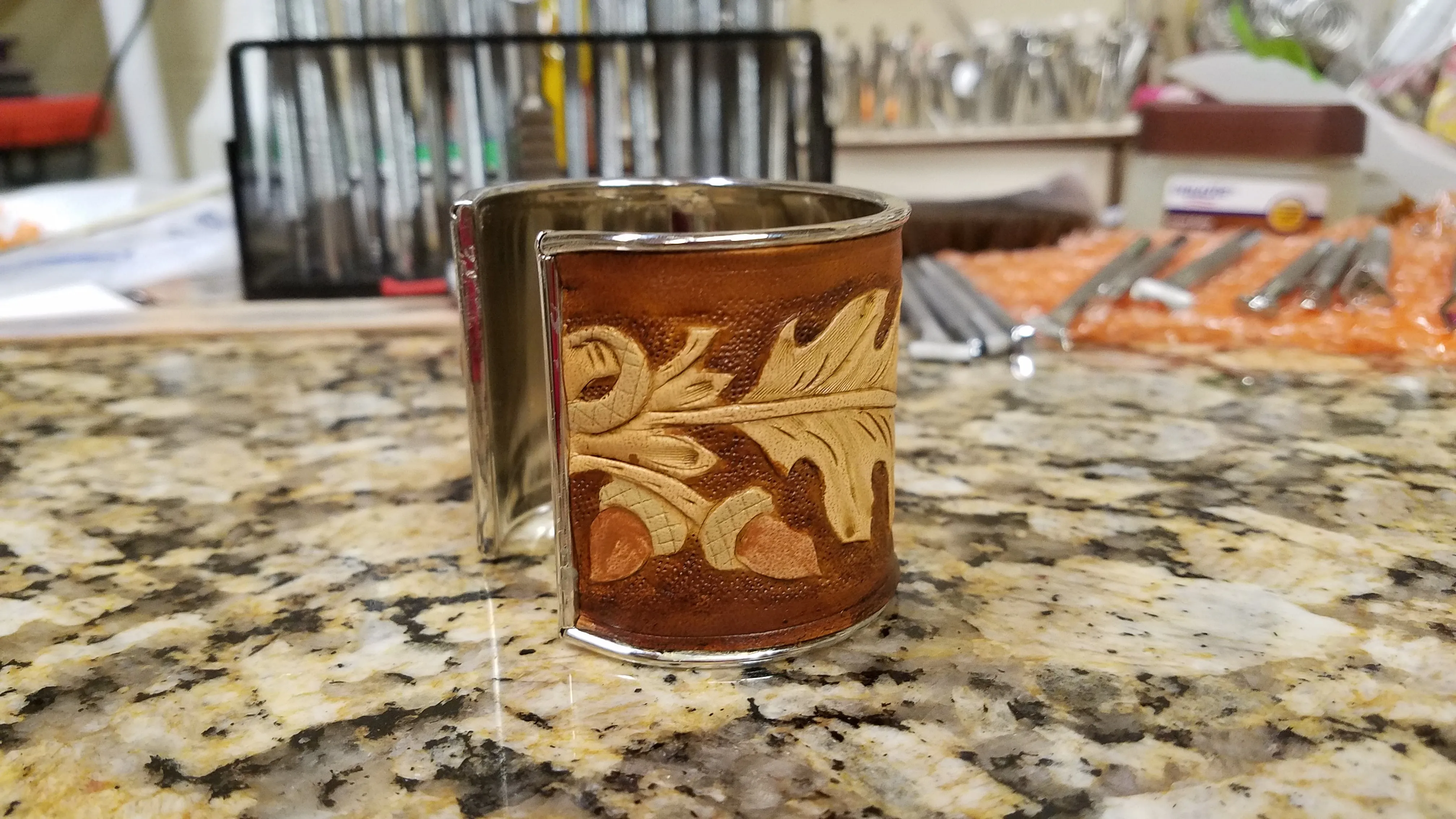 Leather cuff with acorns